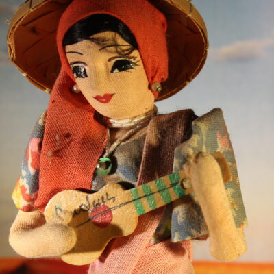 A doll playing the guitar.